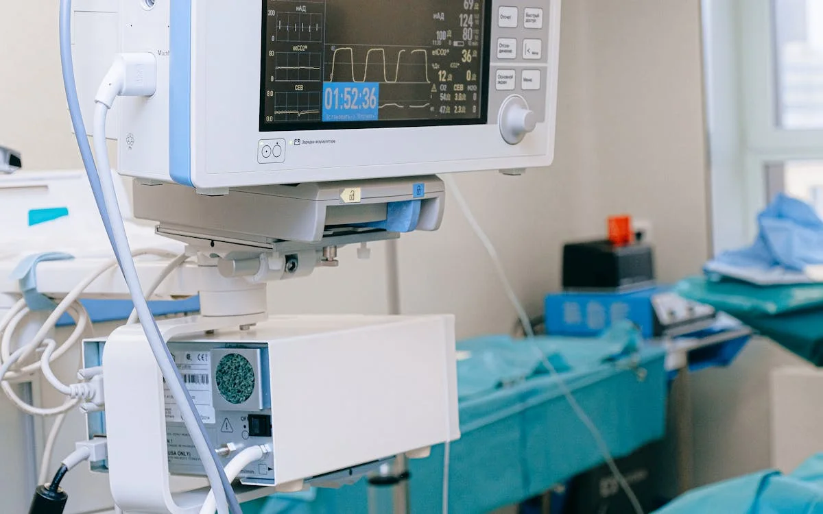 Modern interventional procedure room with medical monitoring equipment for OBL financing